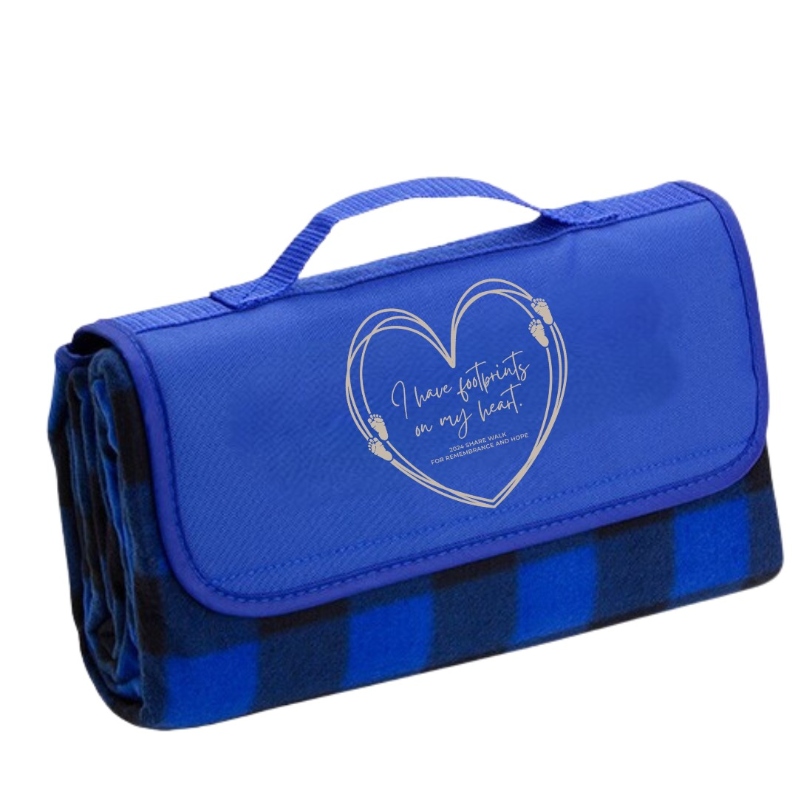 Product Description: Share picnic blanket. Folds to a compact size with carrying handle for easy portability. Soft blue and black plaid blanket surface. Underside has a black water-resistant material, perfect for outdoor or indoor use. Tan "I Have Footprints On My Heart" Logo.</br> Picnic Blanket