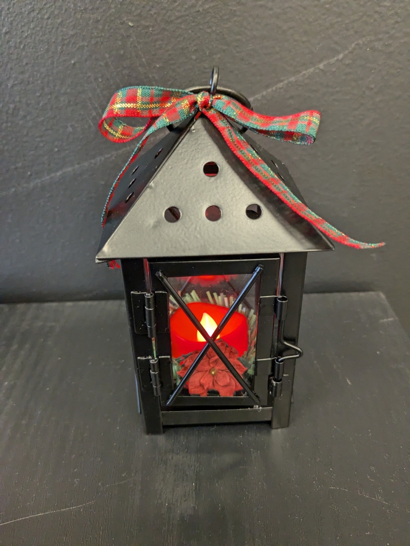 Product Description: "Your Love Lights My Path". Lantern ornament with red flameless tea light candle and greenery. Has hook to hang ornament and tied with ribbon. Available in black and white.</br> Lantern Ornament